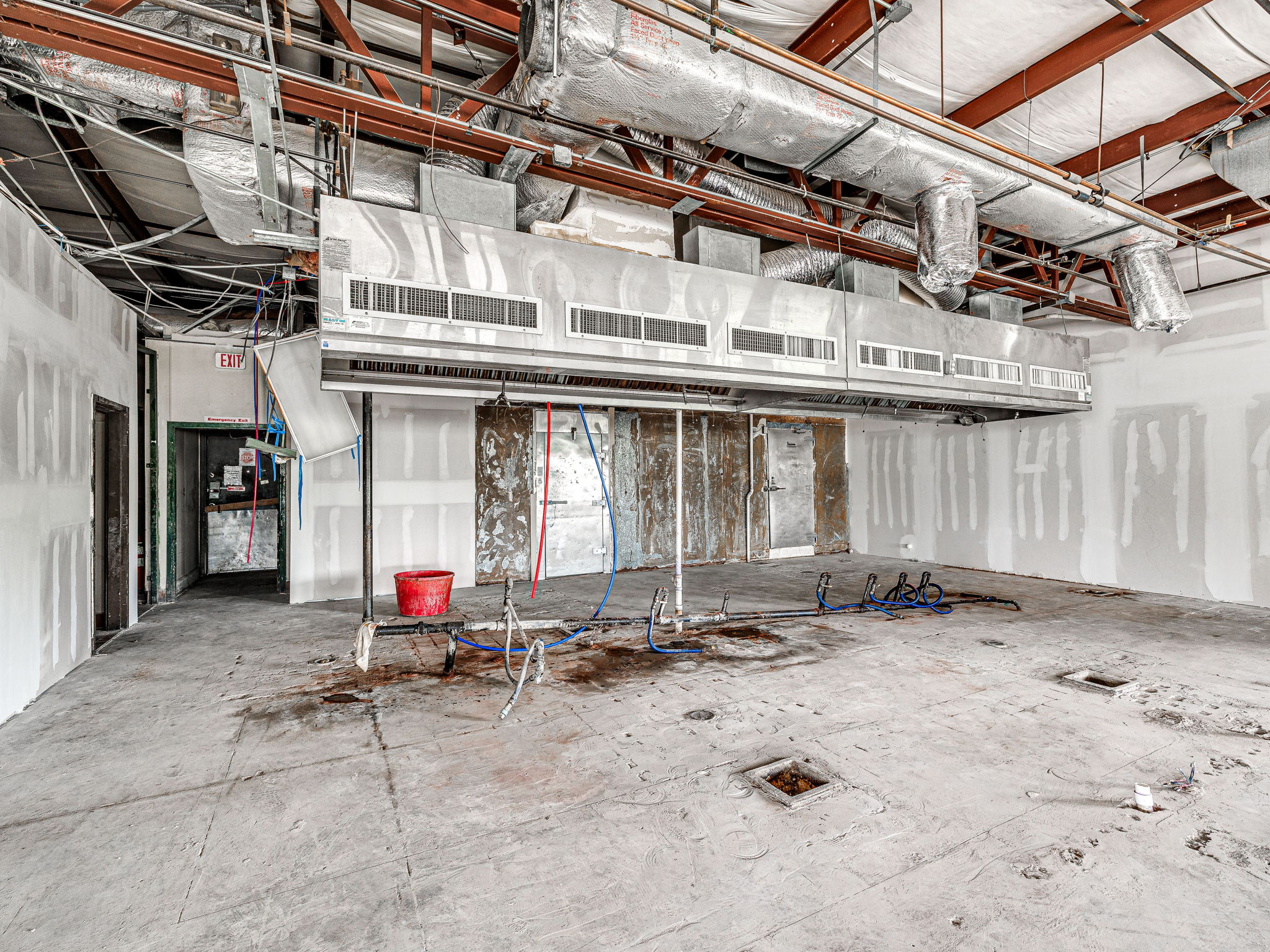 Commercial exhaust hood, gas and plumbing rough-ins, and walk-in cooler openings inside the building
