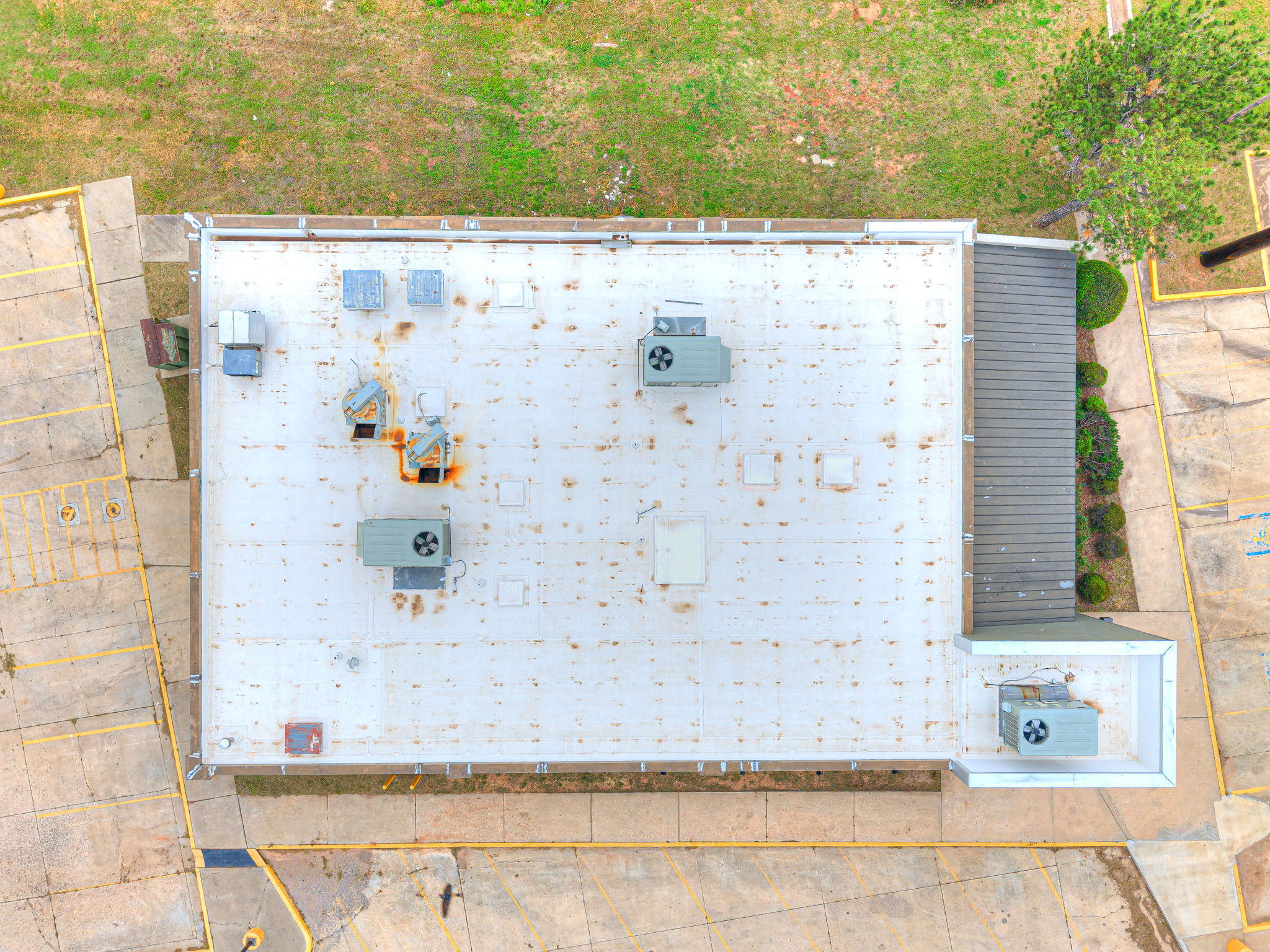Aerial top-down view of the white membrane roof and rooftop HVAC units